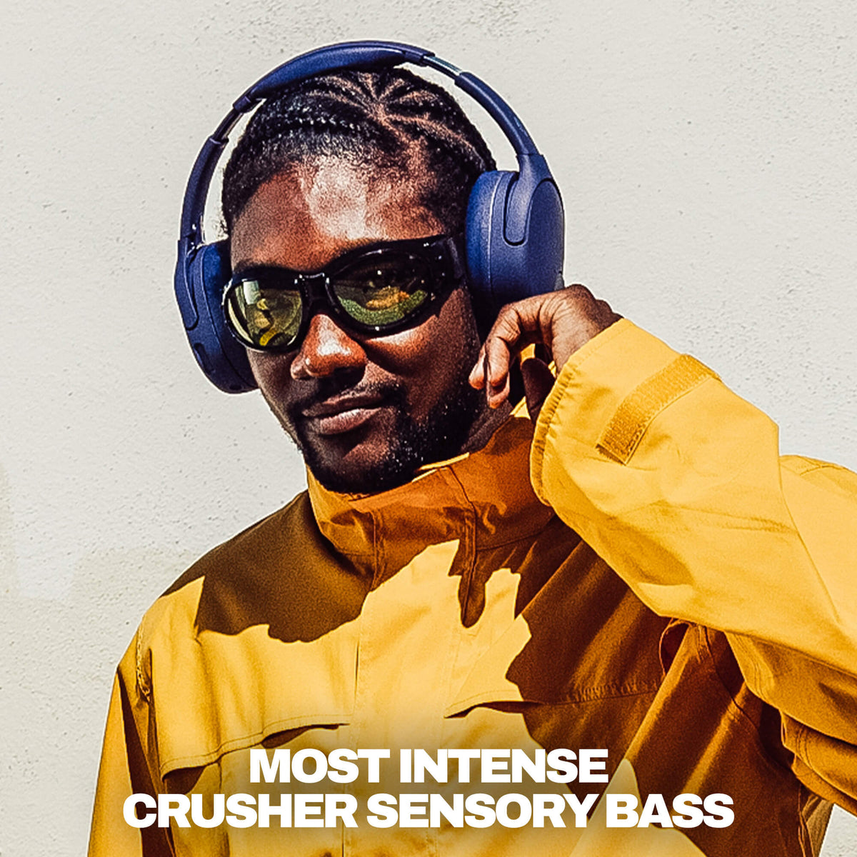 Future | A man wearing deep blue Crusher 720 over-ear headphones,  sunglasses, dressed in a mustard yellow jacket, against a white wall. White text at the bottom reads 'MOST INTENSE CRUSHER SENSORY BASS'.
